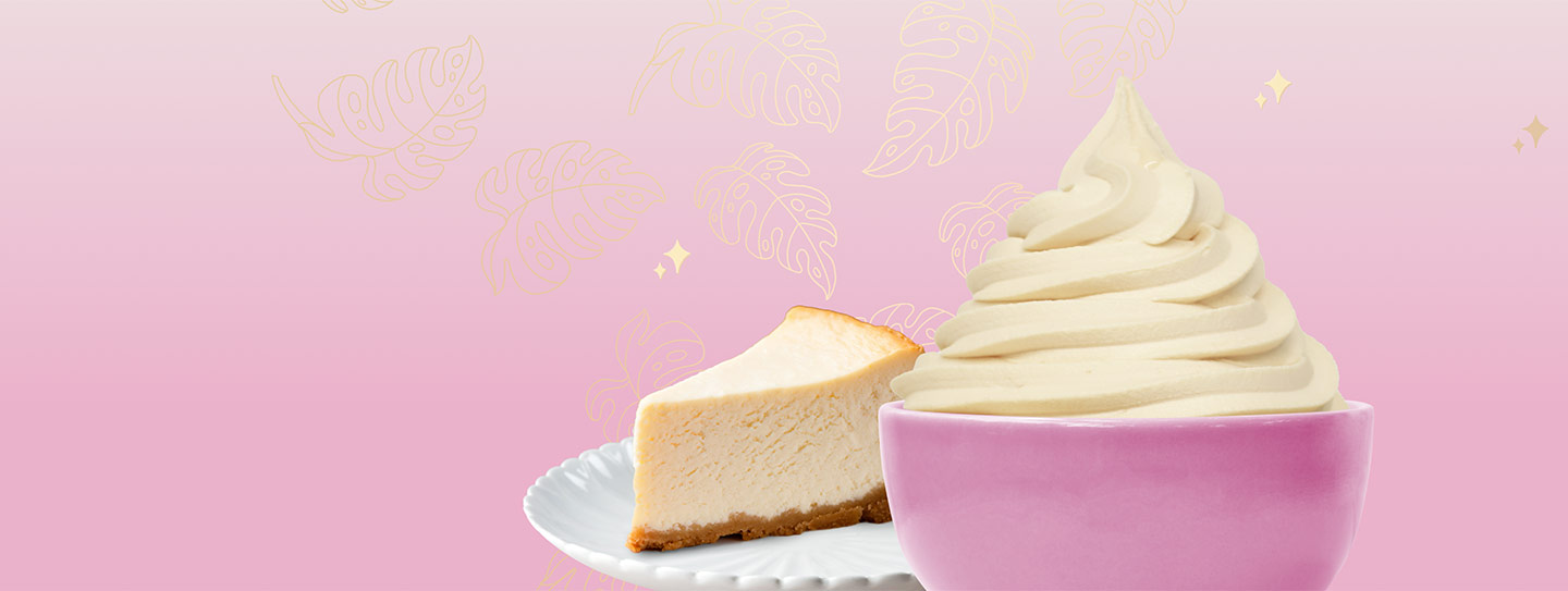 A cup of frozen yogurt alongside a slice of pumpkin pie and pumpkins.