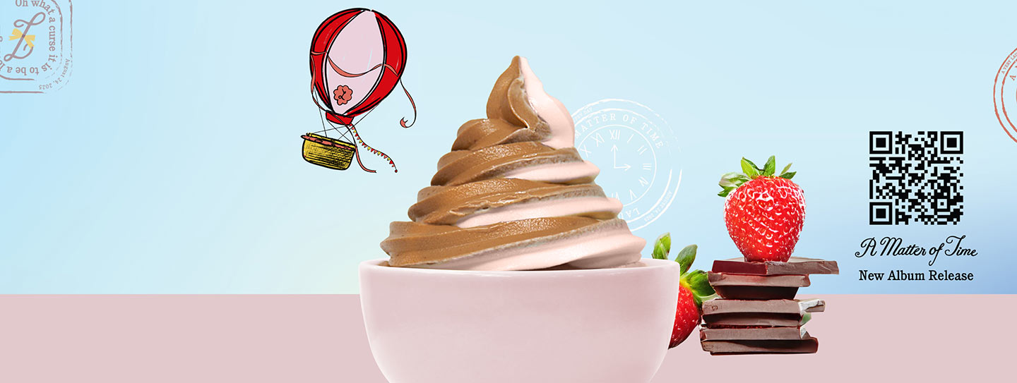 A cup of frozen yogurt alongside strawberries and chocolate.