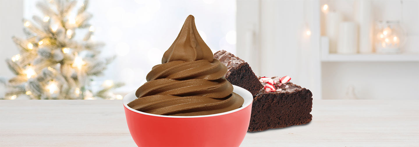 A cup of frozen yogurt alongside peppermint brownies.