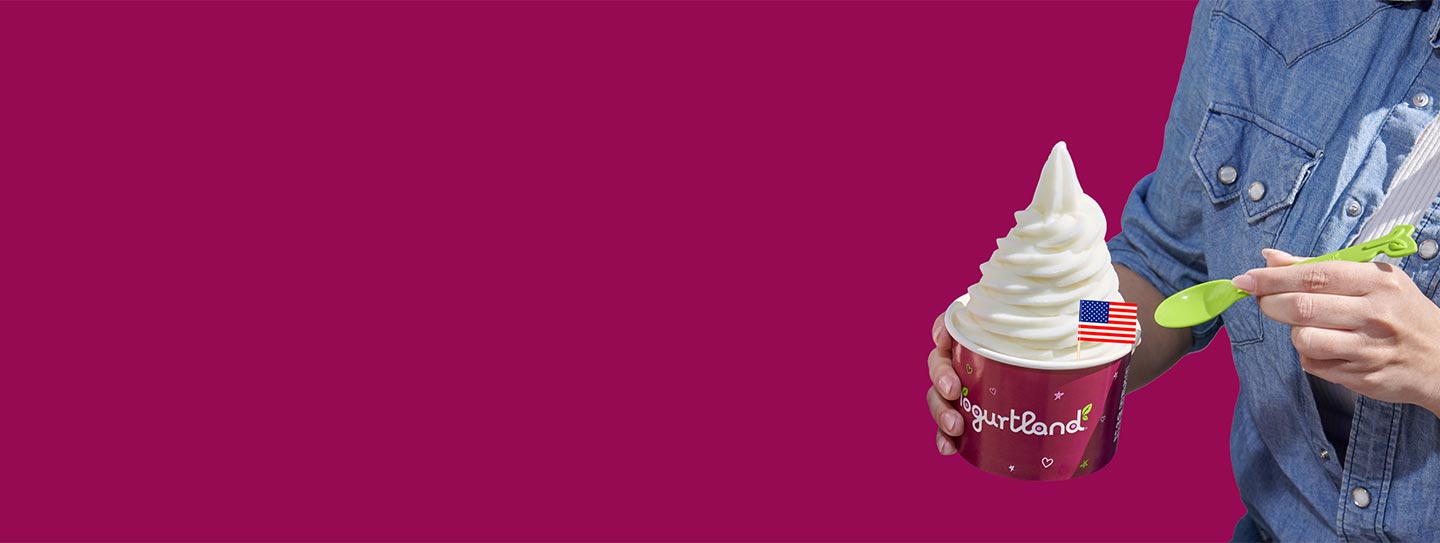 A cup of Yogurtland frozen yogurt with an American flag